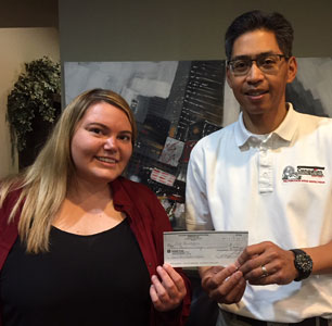 Home inspector Alex, presents cheque to contest winner