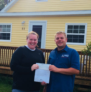 home inspector Cape Breton with contest winner in front of a house