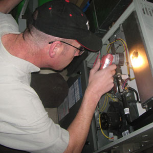 home inspector using a light to see inside