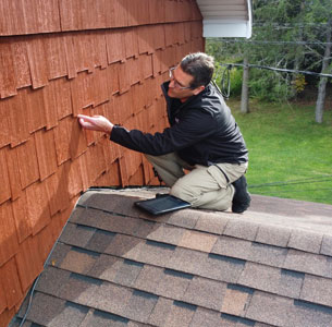 home inspector in Fredericton checking siding