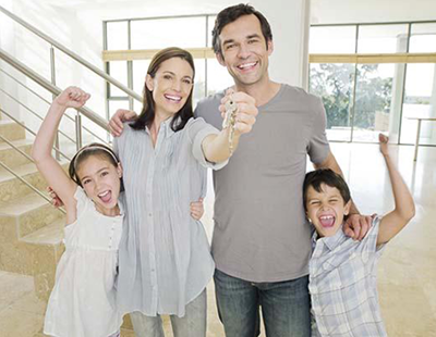 family holding keys to new home