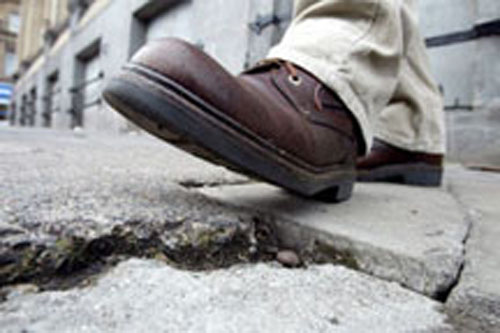 boot stepping onto cracked concrete