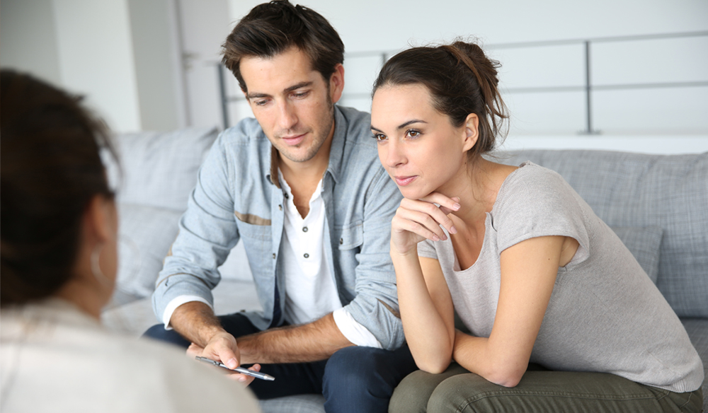 couple listening to why they should attend the home inspection