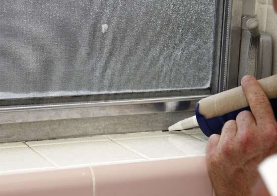 caulk gun on window