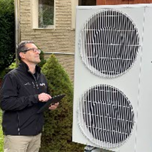 home inspector looking at heat pump outdoor unti