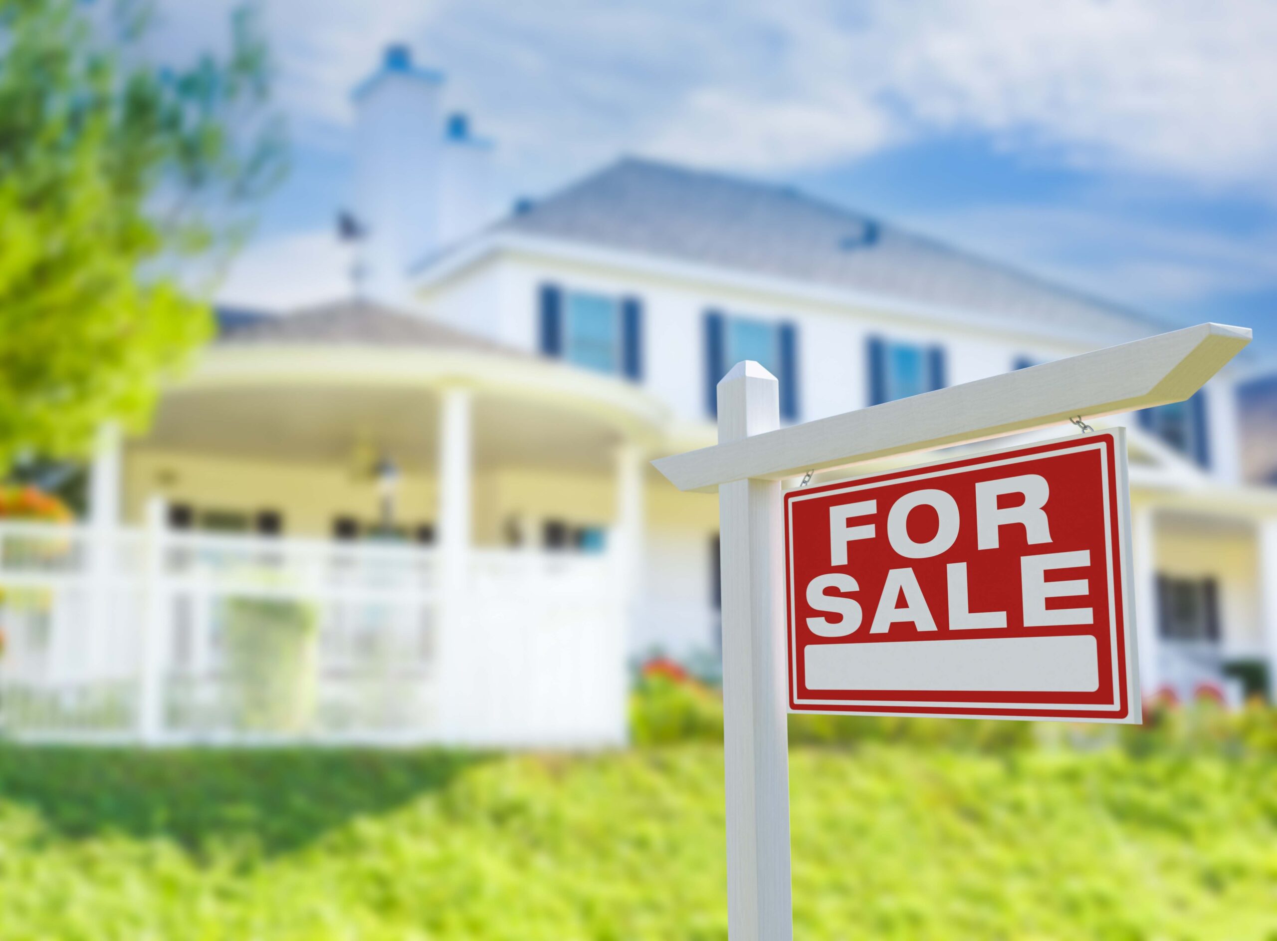 for sale sign in front of a home faded in background